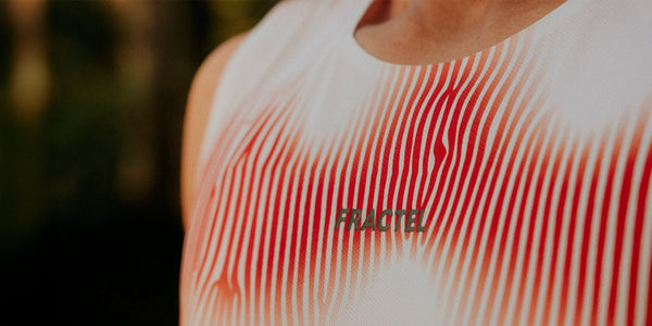 Close-up of a white Fractel running singlet with a red wave pattern print and FRACTEL lettering