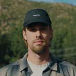Runner wearing the black Fractel CP-JET fitted running cap outdoors