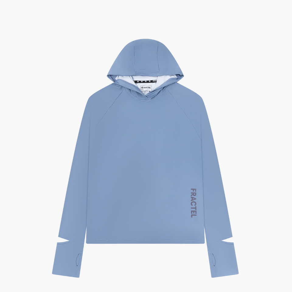 A light blue pullover hoodie with a white inner hood lining, featuring the brand name 'FRACTEL' printed vertically in dark gray on the lower right side of the chest and on the sleeve cuff.