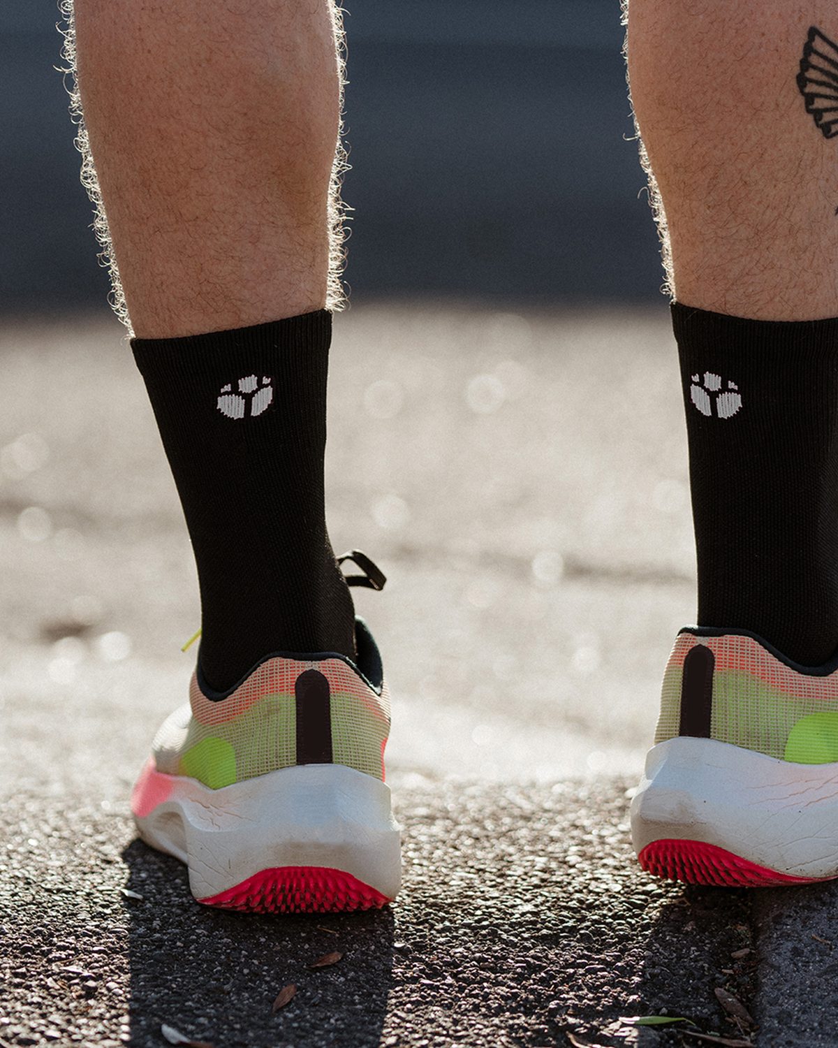 Close-up of black Fractel running socks, one of our running accessories