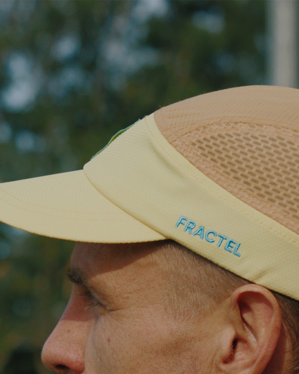 City series running cap in pale yellow worn outdoors
